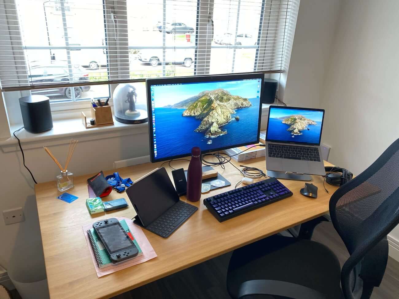 Duncan's desk with iPad, Switch, MacBook and monitor