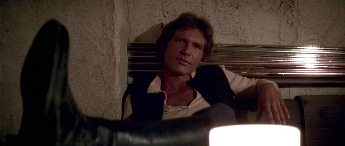 A photo of han solo with his feet kicked up.