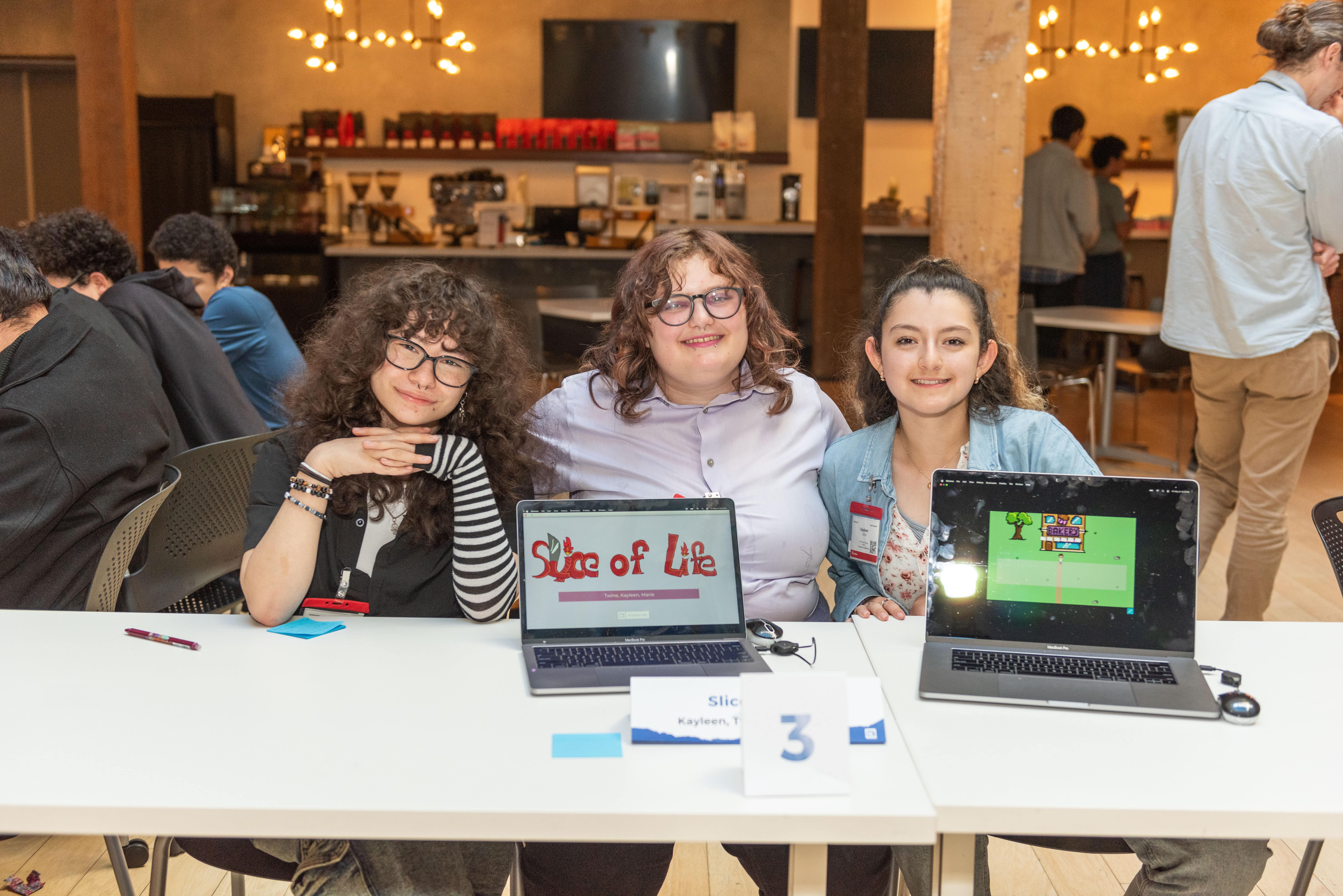 Students posing with laptops.
